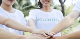 Volunteers standing hands