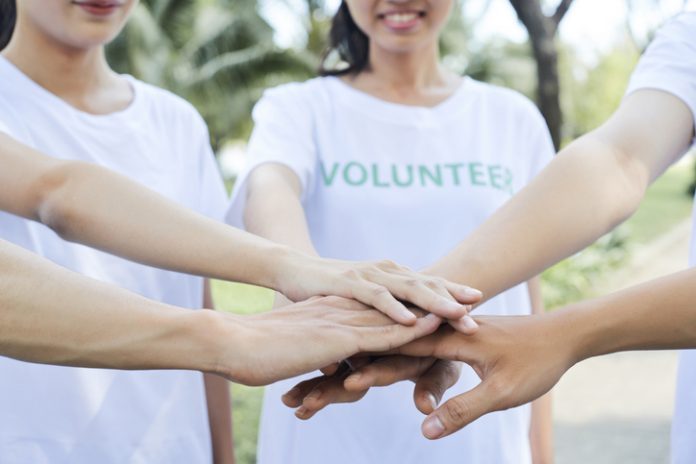 Volunteers standing hands