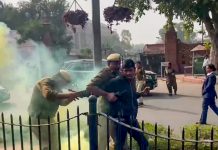 Two protestors protesting with colour smoke have been detained by the police