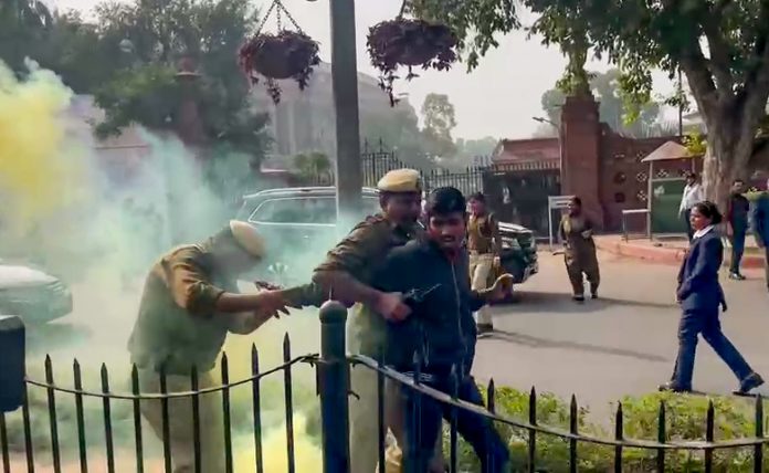 Two protestors protesting with colour smoke have been detained by the police