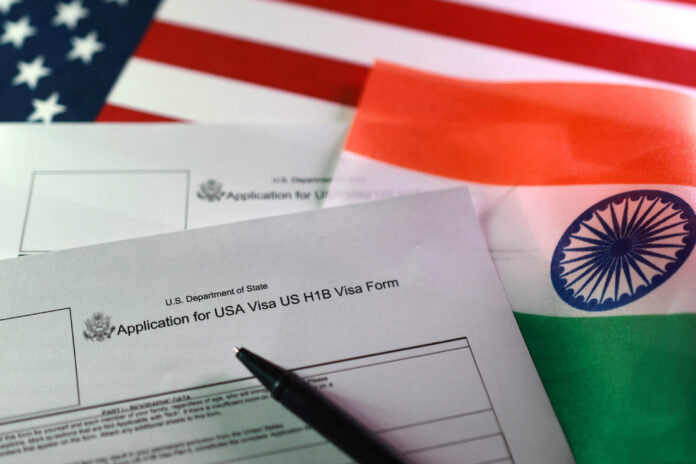 Illustration shows U.S. and Indian flags, U.S. H-1B Visa application forms