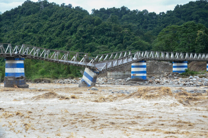 The collapsed Dudhia Iron Bridge over the Balason River after torrential rains in Darjeeling