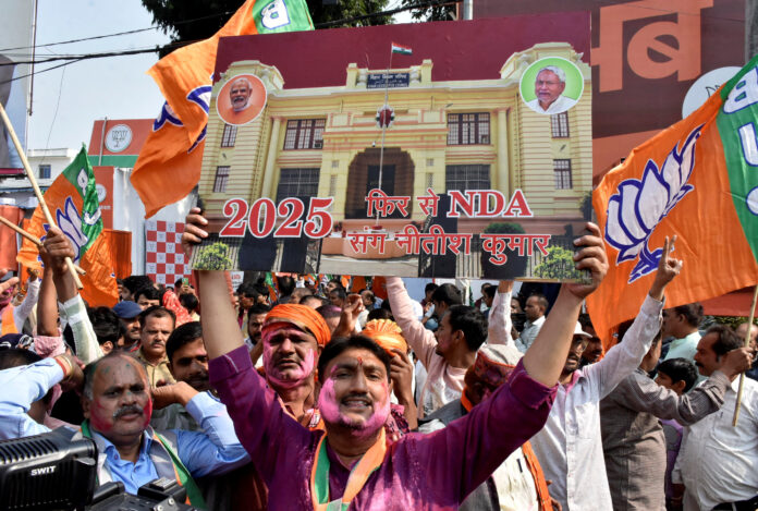 BJP supporters celebrate as early trends show the ruling National Democratic Alliance leading in the Bihar state assembly election results, in Patna