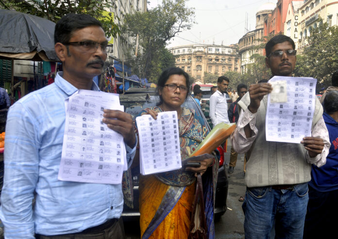 BJP activists display the voter lists after their names were deleted from the voter list