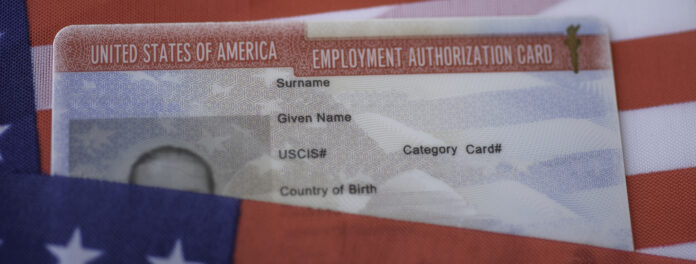Employment Authorization card on USA Flag surface. Close up view.
