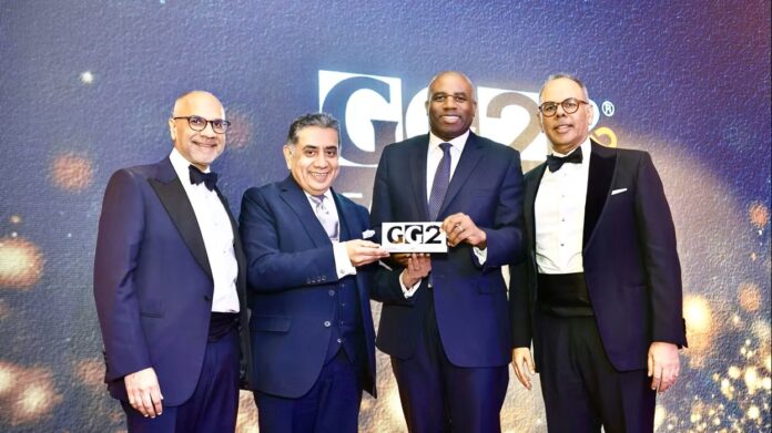 shailesh-solanki-lord-tariq-ahmad-david-lammy-and-kalpesh-solanki-pose-for-photo-after-lammy-was-awarded-the-gg2-hammer-award