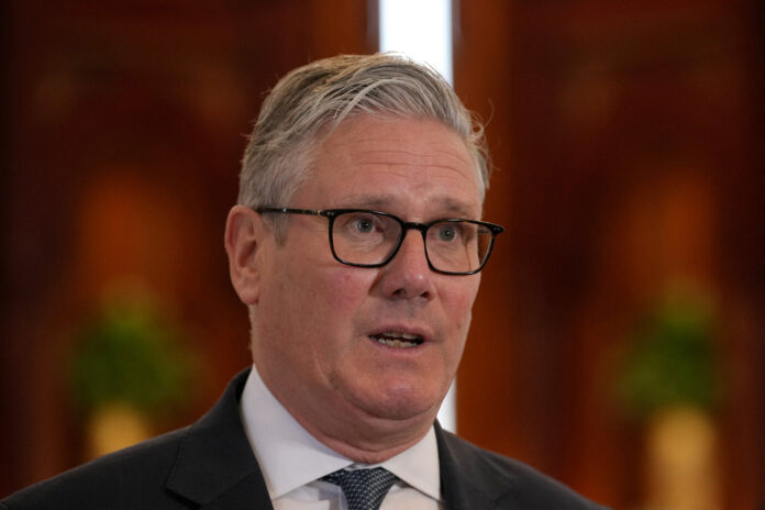 FILE PHOTO: Britain's Prime Minister Keir Starmer speaks to the media at the airport in Doha